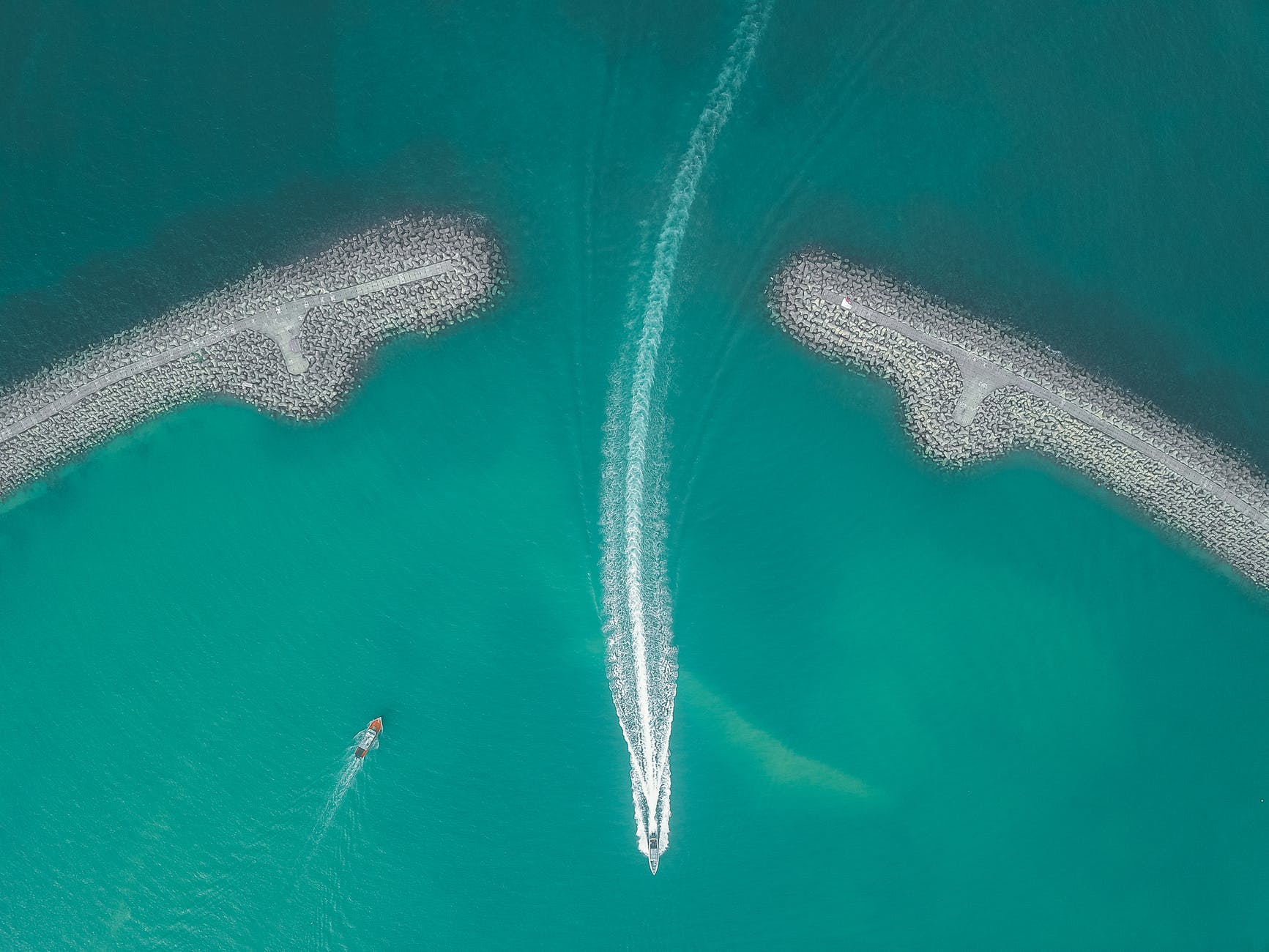 boats floating in clean bright water of sea