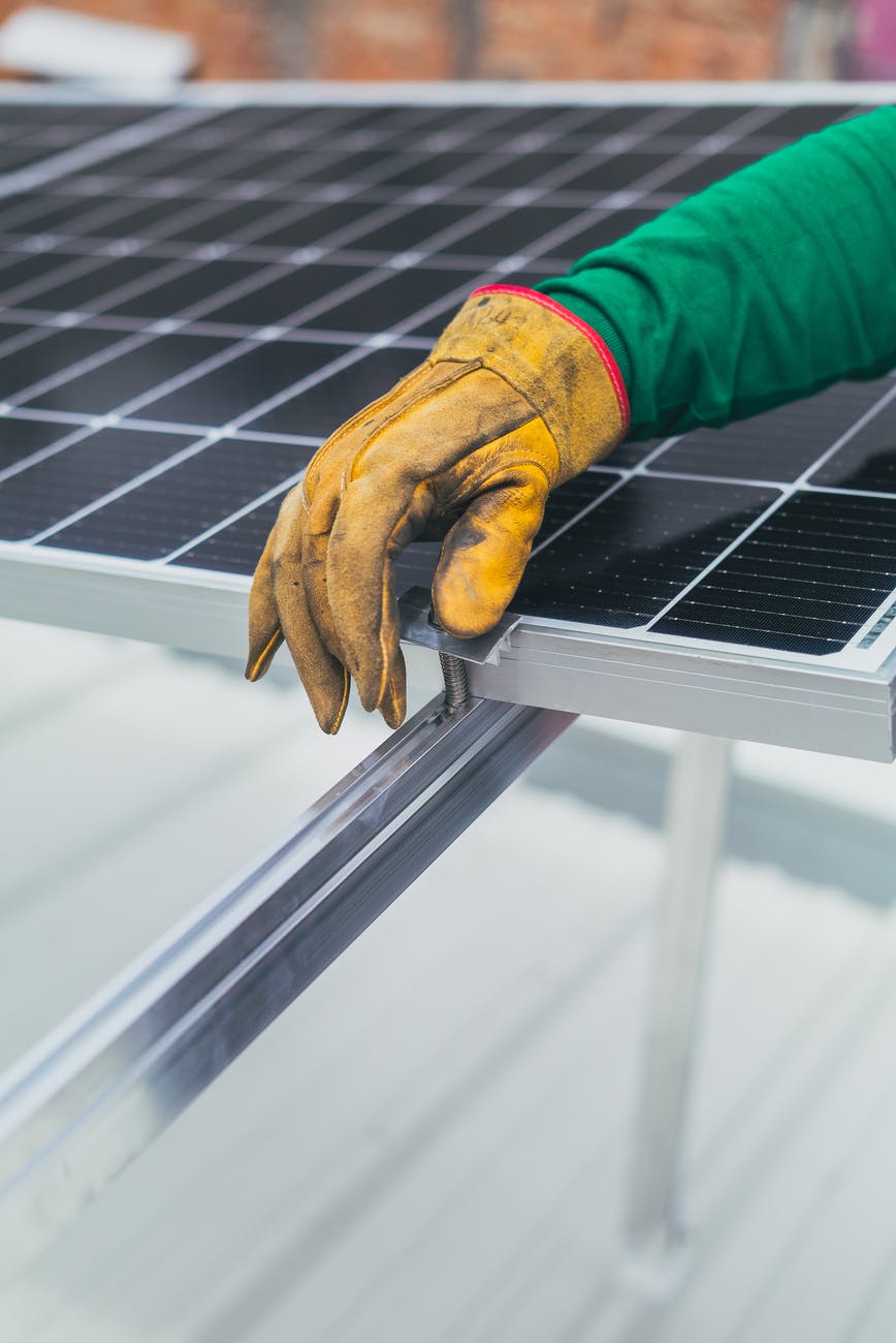 person s hand on top of solar panel