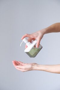 Green Entrepreneurship Makes a Global Impact woman applying hand sanitizer