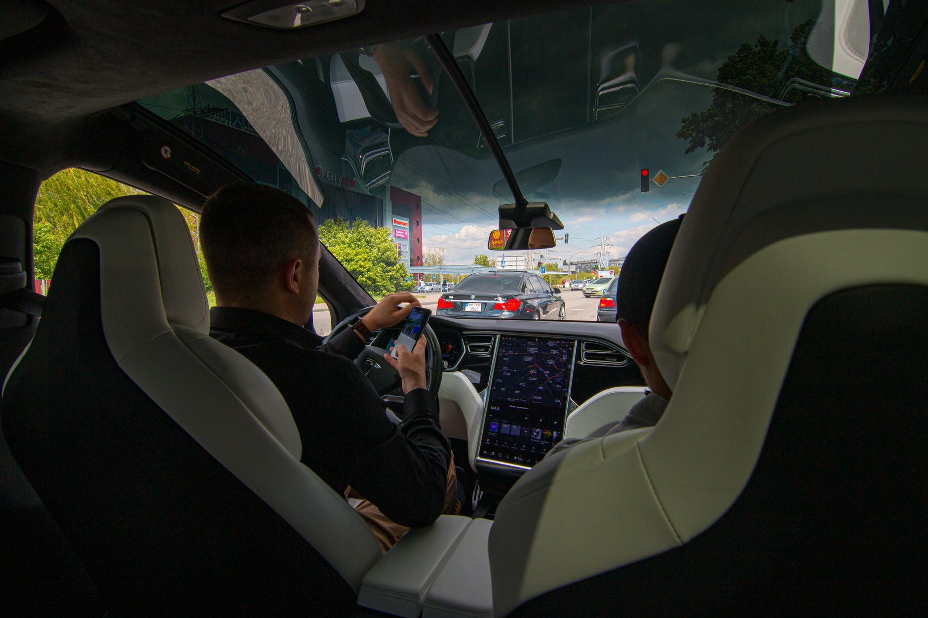 man driving a tesla