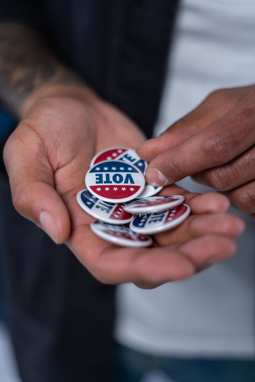 hands with vote pins