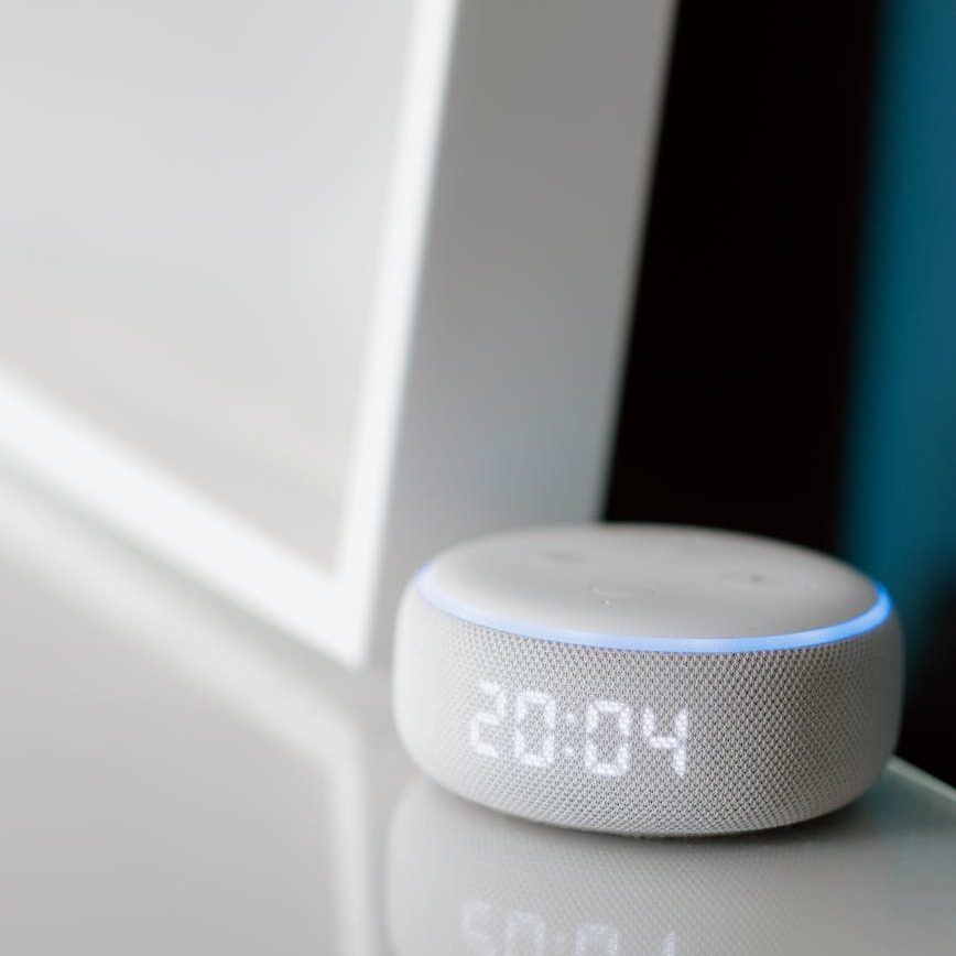 white smart speaker on the table