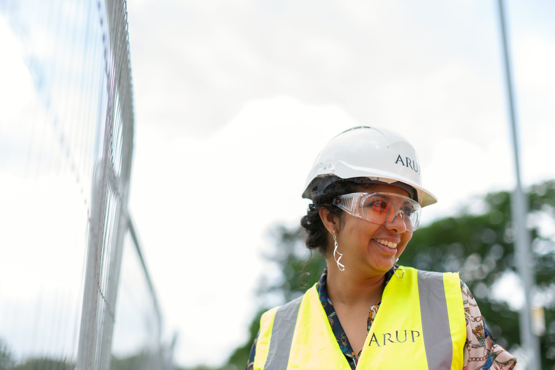 photo of female engineer wearing hard hat and yellow vest