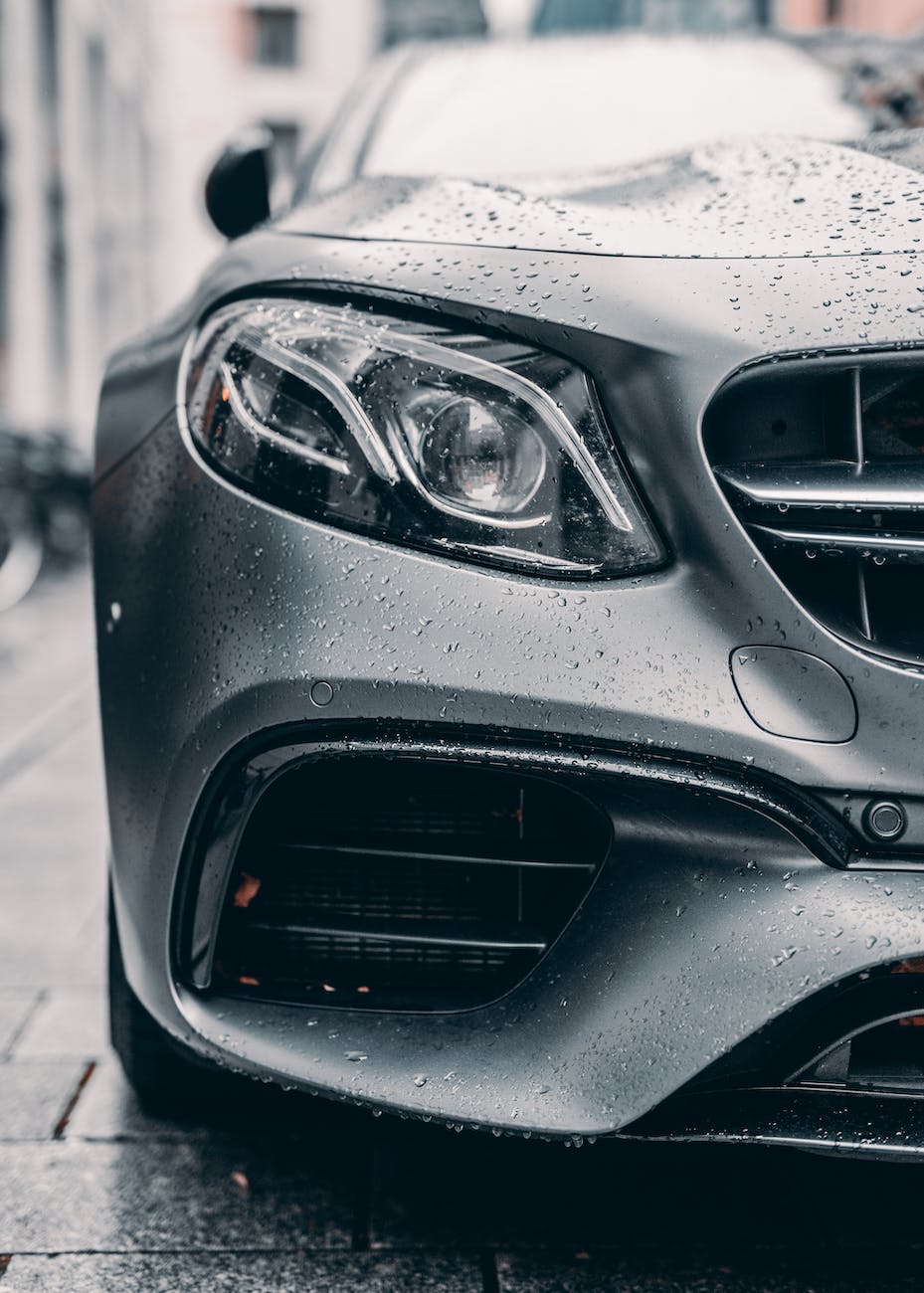 half of gray car placed on city street